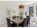 Bright dining room featuring a wooden table, seating for six, a pendant light, and large windows at 2544 Barrington Ct, Rock Hill, SC 29732