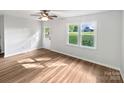 Spacious room with hardwood floors, a ceiling fan, and natural light streaming through the window at 269 Bud Black Rd, Crouse, NC 28033