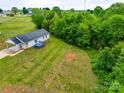 Aerial view of a home with a large, lush backyard surrounded by mature trees at 301 Walkers Ridge Dr, Shelby, NC 28152