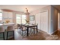 Dining room with hardwood floors, modern chandelier, area rug, and large window providing natural light at 301 Walkers Ridge Dr, Shelby, NC 28152