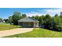 Charming single-story house with a welcoming yellow door, carport, and lush green lawn at 301 Walkers Ridge Dr, Shelby, NC 28152