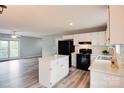 Bright kitchen with white cabinets, an island, modern appliances and a seamless flow into the living space at 301 Walkers Ridge Dr, Shelby, NC 28152