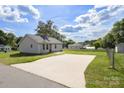 View of backyard with large parking pad and detached garage potential at 318 Huffman Rd, Gastonia, NC 28056
