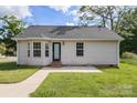 A cozy home featuring a well-maintained lawn and charming architecture at 318 Huffman Rd, Gastonia, NC 28056