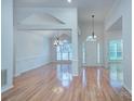 Spacious, light-filled living room features gleaming hardwood floors, high ceilings and chandelier lighting at 3226 Chatfield Sw Ln, Concord, NC 28027