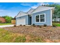 Close up of a light blue home with white trim and fresh landscaping at 3567 Farmfield Dr, Claremont, NC 28610