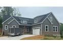 Stylish home showcasing gray siding, brick accents, a two-car garage, and a welcoming entrance at 3733 Whitney Ne Dr, Hickory, NC 28601