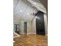Spacious living room with vaulted ceilings, hardwood floors, and a modern fireplace, creating an inviting atmosphere at 3733 Whitney Ne Dr, Hickory, NC 28601