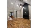 A spacious living room boasts vaulted ceilings, hardwood floors, and a modern fireplace, with a staircase nearby at 3733 Whitney Ne Dr, Hickory, NC 28601