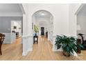 Inviting hallway with hardwood floors, archways, and decorative plants at 3748 Tea Olive Rd, Gastonia, NC 28056