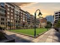 Exterior view of the building's terrace and manicured lawn at 400 N Church St # 413, Charlotte, NC 28202
