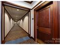 Hallway of a condo with patterned carpet and painted walls at 400 N Church St # 413, Charlotte, NC 28202