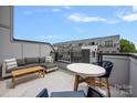 Inviting rooftop deck with comfortable seating, a table, and views of the surrounding neighborhood at 4002 Tundra Rd, Charlotte, NC 28203