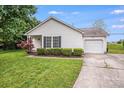 Charming single-story home with white siding, blue shutters, a well-manicured lawn, and an attached one-car garage at 4227 Coopersdale Rd, Charlotte, NC 28273