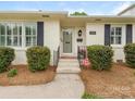 Inviting front entrance with a well-kept walkway, trimmed bushes, and a secure CPI security system at 4346 Walker Rd, Charlotte, NC 28211