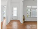 Bright foyer with hardwood floors, white walls, and a glass front door providing ample natural light at 471 Lucky Nw Dr, Concord, NC 28027