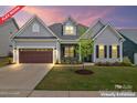 Charming home featuring a screened porch, a brown garage door, and a beautifully landscaped front yard at 471 Lucky Nw Dr, Concord, NC 28027