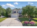Charming two-story home featuring a well-kept lawn, a lush garden, and a concrete driveway at 4853 Walnut Grove St, Harrisburg, NC 28075
