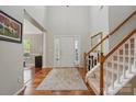 Spacious foyer featuring hardwood floors, staircase, and a column accent at 4853 Walnut Grove St, Harrisburg, NC 28075