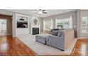 Cozy living room boasts a fireplace, built-in shelving, large windows, and a plush sofa at 4853 Walnut Grove St, Harrisburg, NC 28075