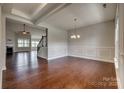 Spacious dining room featuring hardwood floors and elegant trim work with an adjacent living room at 4926 Trayton Ave, Gastonia, NC 28056
