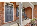Close-up view of the front entrance with a black door and cozy porch seating at 4926 Trayton Ave, Gastonia, NC 28056