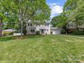 Beautiful two-story home with lush green lawn and mature trees in a quiet neighborhood at 5817 Portburn Rd, Charlotte, NC 28211