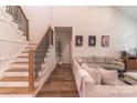 Bright living room showcasing a staircase, comfortable seating, and stylish decor for a welcoming atmosphere at 602 Kames Nw Ct, Conover, NC 28613