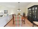 Elegant dining room featuring a classic china cabinet, chandelier, and a spacious table with seating for six at 6645 Gaywind Dr, Charlotte, NC 28226