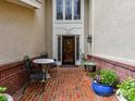 Inviting brick front porch with stylish seating creates a welcoming entrance to the home at 6645 Gaywind Dr, Charlotte, NC 28226