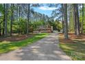 Exterior view of a two-story home with a long driveway lined with trees and a spacious front yard at 836 Meadowlark Dr, Rock Hill, SC 29732