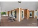 Covered porch with a brick accent wall and seating area at 836 Meadowlark Dr, Rock Hill, SC 29732