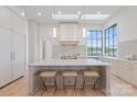 Well-lit kitchen island with pendant lights and a marble countertop at 8397 Ranger Island Marina Rd, Denver, NC 28037