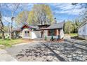 Charming one-story home with white siding, orange trim, and a welcoming front porch at 908 W Airline Ave, Gastonia, NC 28052