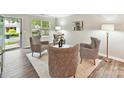 Bright living room featuring modern decor, hardwood floors, and ample natural light at 9723 Mattforest Cir, Charlotte, NC 28277