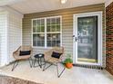 Inviting front porch with stylish seating, perfect for relaxing and enjoying the outdoors at 9723 Mattforest Cir, Charlotte, NC 28277