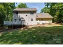 Backyard view of the home featuring a wooden deck perfect for relaxing outdoors at 122 Roxboro Ct # 286, Mount Gilead, NC 27306