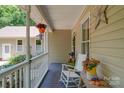 Cozy front porch featuring a rocking chair, hanging plants, and decorative accents at 122 Roxboro Ct # 286, Mount Gilead, NC 27306