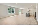 Bright and airy living room featuring hardwood floors, recessed lighting, and access to the backyard at 134 Dorian Pl, Troutman, NC 28166