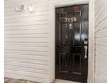 This home has a modern black front door and shiny gold hardware at 3158 Walnut Park Dr, Charlotte, NC 28262