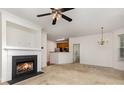 Cozy living room featuring neutral carpet, a fireplace and views into the kitchen at 3158 Walnut Park Dr, Charlotte, NC 28262