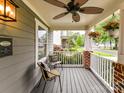 Cozy front porch with seating, hanging flower baskets, and a view of the neighborhood street at 335 Greystone Rd, Charlotte, NC 28209