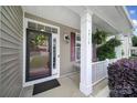 Inviting front entry featuring a decorative wreath, covered porch, and charming architectural details at 4016 Garden Oak Dr, Indian Trail, NC 28079