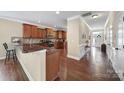 Open kitchen features granite countertops, wood cabinets, stainless appliances, and hardwood flooring at 4016 Garden Oak Dr, Indian Trail, NC 28079