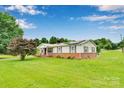 Charming single-story home with a brick foundation and landscaped front yard, showcasing its curb appeal at 543 18Th Nw St, Hickory, NC 28601