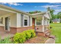 Inviting front porch with brick accents, providing a cozy entrance to the charming single-story home at 543 18Th Nw St, Hickory, NC 28601