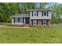 Charming two-story home with a combination of brick and vinyl siding and black shutters at 6443 Eaglecrest Rd, Charlotte, NC 28212