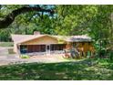 Secluded backyard featuring a screened porch and deck, nestled in a green, tree-filled landscape with brick home at 6447 E Nc 27 Hwy, Iron Station, NC 28080