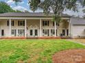 Inviting townhome showcasing a well-maintained lawn and classic colonial architectural details at 7004 Quail Hill Rd, Charlotte, NC 28210