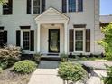 A close up of a home's front door featuring white columns and lush landscaping at 8200 Lansford Rd, Charlotte, NC 28277